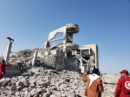 Red Crescent medics stand at the site of Saudi-led air strikes on a Houthi detention centre in Dhamar