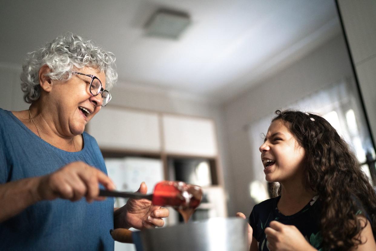 Grandmother making chocolate with granddaughter at home