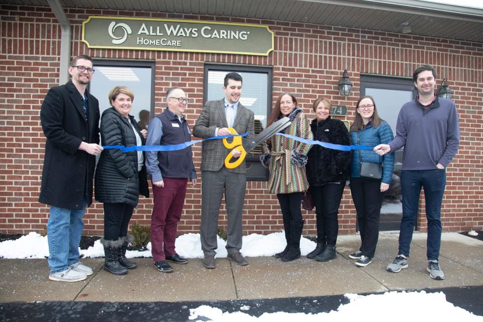 All Ways Caring Home Care branch manager Chase Thurber cuts the ribbon for their grand opening in Chillicothe on Jan. 28, 2022.