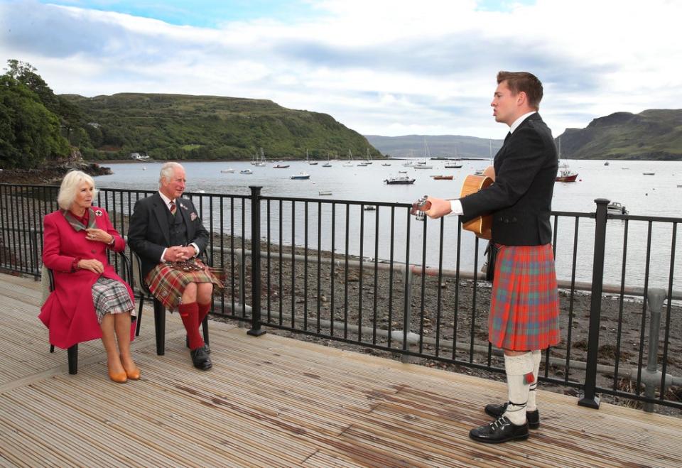 Gaelic singer, Robert Robertson, entertains the Prince of Wales and Duchess of Cornwall, known as the Duke and Duchess of Rothesay when in Scotland, during their visit to Portree (William Urquhart/PA) (PA Wire)