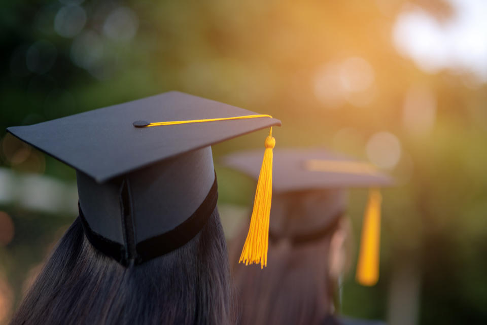 Back portrait of graduated wearing a black hat.