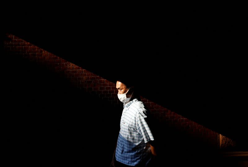 Man makes his way under a strong sun beam in Tokyo