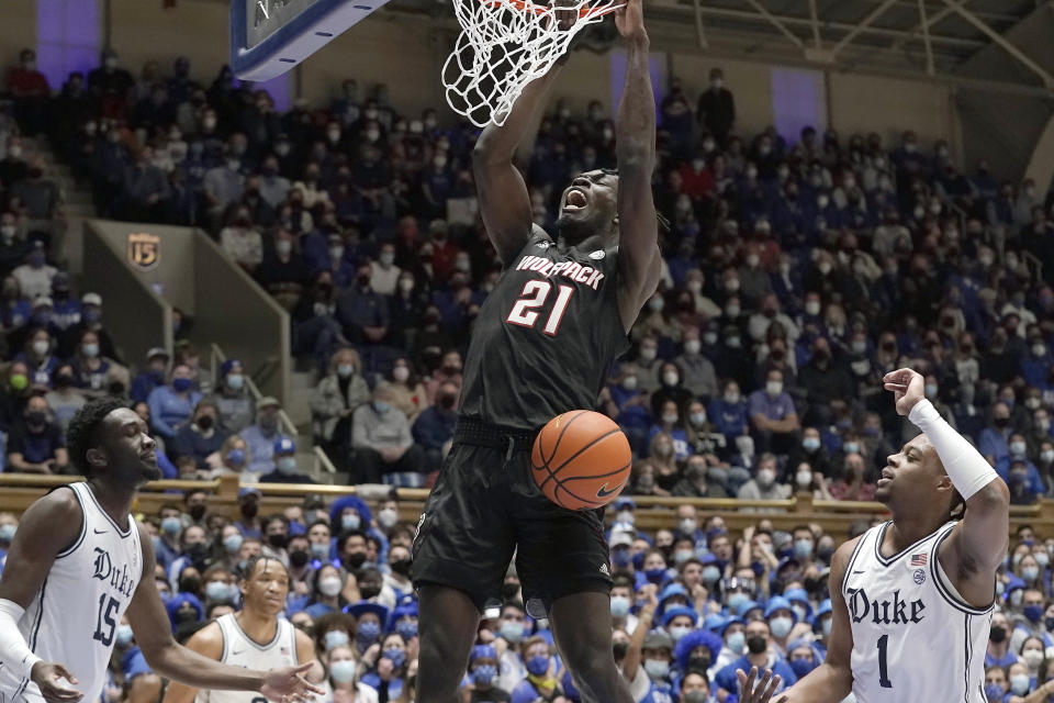 North Carolina State forward Ebenezer Dowuona (21) dunks as Duke center Mark Williams (15) and guard Trevor Keels (1) look on during the first half of an NCAA college basketball game in Durham, N.C., Saturday, Jan. 15, 2022. (AP Photo/Gerry Broome)