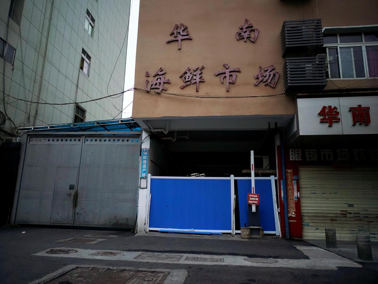 A blocked entrance to Wuhan's Huanan market, where the coronavirus that can cause Covid-19 is believed to have first surfaced: Reuters