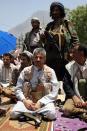 Hammud Said al-Mikhlafi (C), commander of the Popular Resistance Committees loyal to President Abedrabbo Mansour Hadi, is seen kneeling during Friday prayers in the southwestern Yemeni city of Taez on April 17, 2015