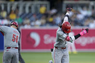 Cincinnati Reds' Elly De La Cruz, right, celebrates with third base coach J.R. House (56) after hitting a home run during the first inning of a baseball game against the San Diego Padres, Monday, April 29, 2024, in San Diego. (AP Photo/Gregory Bull)