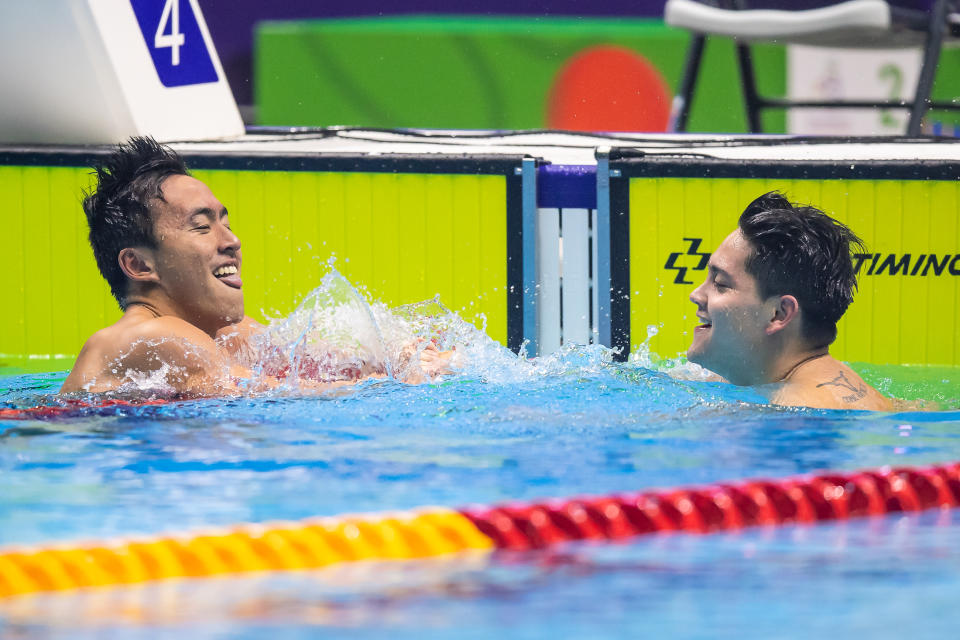 Singapore swimmer Joseph Schooling (right) is being congratulated by compatriot Quah Zheng Wen after winning the men's 100m butterfly gold. (PHOTO: SNOC/Andy Chua)