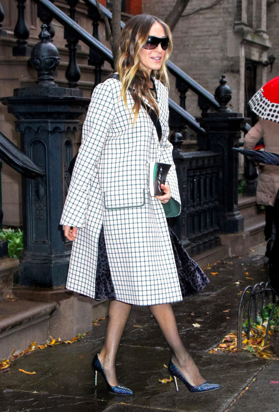 On her way to the Muse Awards in NYC on Thursday, December 13, the actress topped off her velvet black Batsheva frock and sparkly pumps with a grey and white check coat that Carrie Bradshaw would approve of.