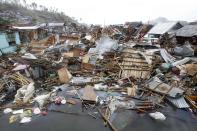 Devastated houses float on sea water after super typhoon Haiyan hit Tacloban city, central Philippines November 11, 2013.