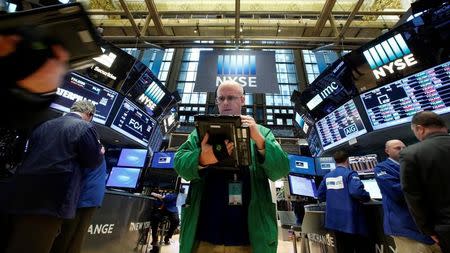 Traders work on the floor of the New York Stock Exchange (NYSE) in New York City, U.S., January 12, 2017. REUTERS/Brendan McDermid