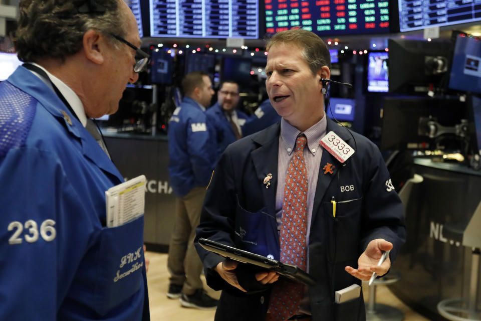 Robert Charmak, right, talks with fellow trader Steven Kaplan on the floor of the New York Stock Exchange, Thursday, Dec. 27, 2018. Wall Street's wild Christmas week goes on, with the Dow Jones Industrial Average slumping 300 points at the open Thursday, a day after notching its biggest-ever point gain. (AP Photo/Richard Drew)