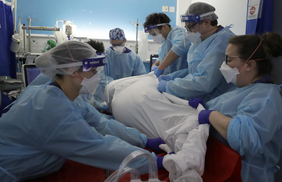 Critical Care staff prone a COVID-19 patient on the Christine Brown ward at King's College Hospital in London, Wednesday, Jan. 27, 2021. The scale of Britain's coronavirus outbreak can seem overwhelming, with tens of thousands of new infections and more than 1,000 deaths added each day. But on hospitals' COVID-19 wards, the pandemic feels both epic and intimate, as staff fight the virus one patient at a time, and with no end in sight. (AP Photo/Kirsty Wigglesworth, Pool)