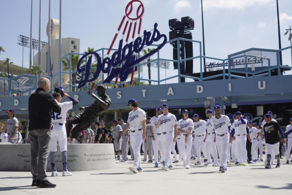 Players and coaches from the Dodgers and Washington Nationals participate in a tribute to Jackie Robinson.