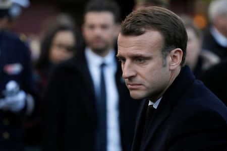 French President Emmanuel Macron gives his condolences to relatives of victims near the 'Le Carillon' bar and 'Le Petit Cambodge' restaurant during a ceremony marking the second anniversary of the Paris attacks of November 2015 in which 130 people were killed, in Paris, France, November 13, 2017. REUTERS/Etienne Laurent/Pool