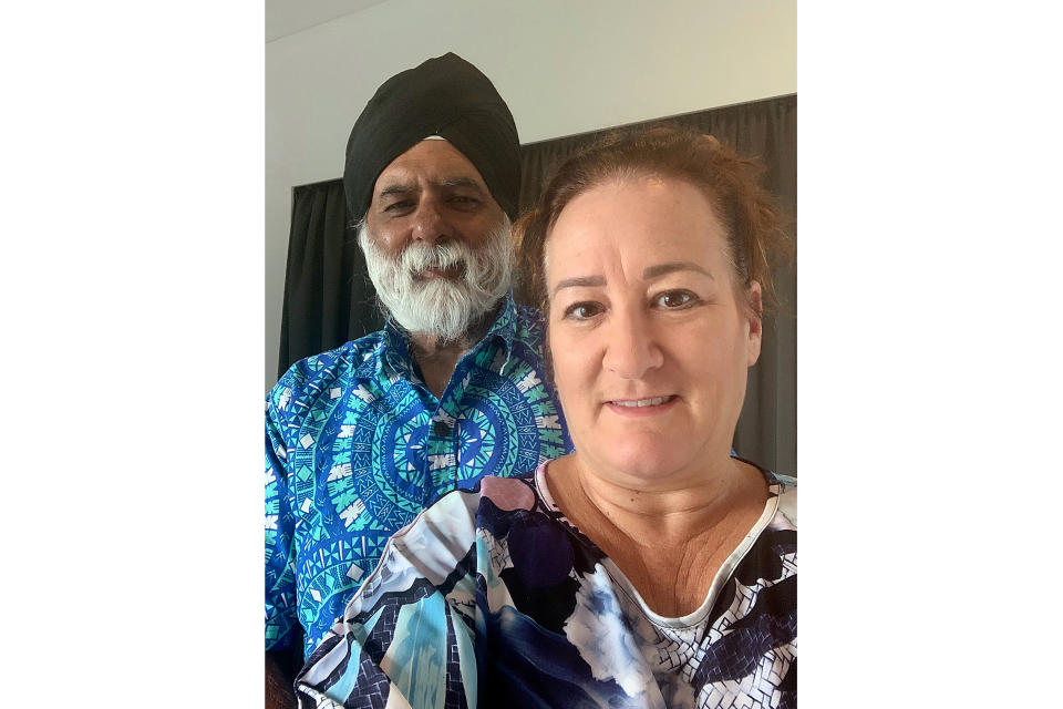 In this photo provided by Sandy Price, Price and her husband, Pal Ahluwalia, pose for a photo in Brisbane, Australia, Friday, Feb. 5, 2021. Ahluwalia, the leader of the University of the South Pacific, and his wife were asleep Wednesday at their Fiji home when a ruckus outside awoke them near midnight. About 15 plain-clothed government agents had surrounded their house in the capital Suva and gave them minutes to pack before they were hastily deported to Australia. (Sandy Price via AP)