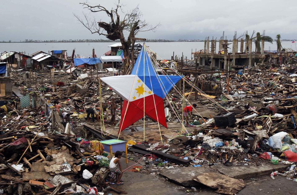 FILE PHOTO: A giant Christmas lantern is seen in a devastated area of Magallanes town, Tacloban city, central Philippines December 22, 2013. Super typhoon Haiyan reduced almost everything in its path to rubble when it swept ashore in the central Philippines on November 8, killing at least 6,069 people, leaving 1,779 missing and 4 million either homeless or with damaged homes. (Source: REUTERS/Romeo Ranoco)