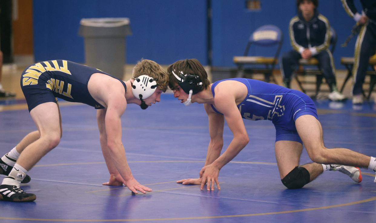 Thomas’s Connor Guffey (L) and Juan Eckebrecht wrestle in the 108 pound match. Guffey won the match 11-6.