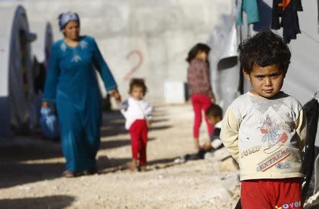 Kurdish refugees from the Syrian town of Kobani walk in a camp in the southeastern town of Suruc, Sanliurfa province October 26, 2014. REUTERS/Kai Pfaffenbach