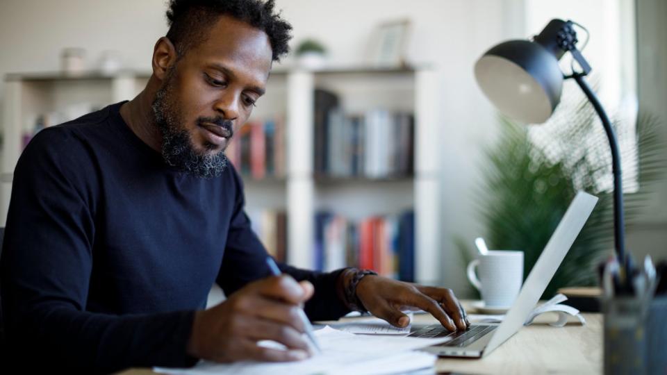 Investor at desk taking notes