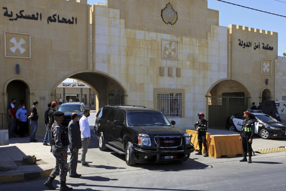 Bassem Awadallah, a former royal adviser, leaves a state security court in a vehicle after the first session of his trial, in Amman, Jordan, Monday, June. 21, 2021. Awadallah, who has Jordanian, U.S. and Saudi citizenship, and Sharif Hassan bin Zaid, a distant cousin of the king, pleaded not guilty Monday to sedition and incitement charges, a defense lawyer said. (AP Photo/Raad Adayleh)