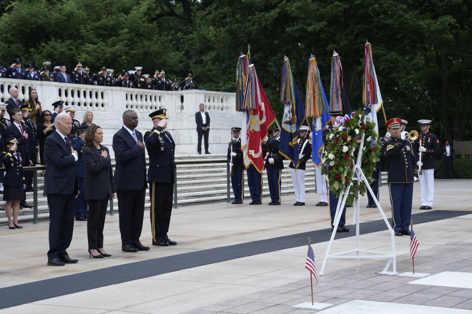 President Joe Biden, left, joined by, from left, Vice President Kamala Harris, Defense Secretary Lloyd Austin and Army Major Gen. Trevor Bradenkamp, listen to the playing of Taps during an Armed Forces Full Honors Wreath Ceremony at the Tomb of the Unknown Soldier at Arlington National Cemetery in Arlington, Va., on Memorial Day, Monday, May 27, 2024. (AP Photo/Susan Walsh)