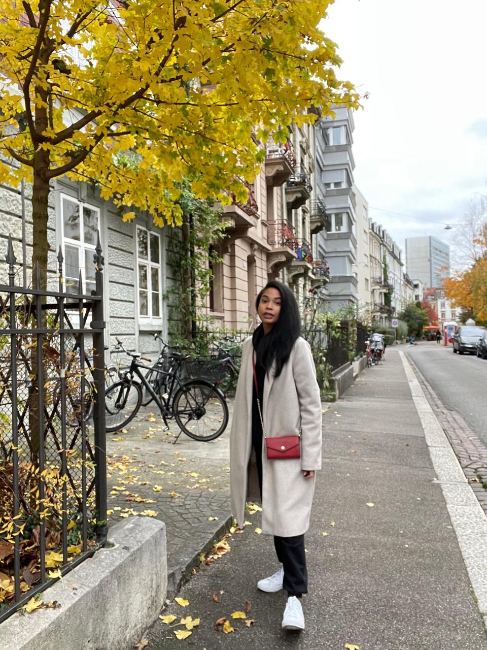 celeste polanco standing in front of buildings in switzerland street