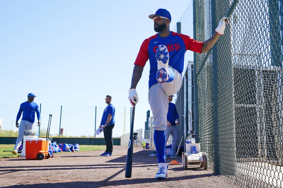 Chicago Cubs' Jason Heyward stretches out as he waits his turn to take batting practice during a spring training baseball workout Tuesday, March 15, 2022, in Mesa, Ariz. (AP Photo/Ross D. Franklin)