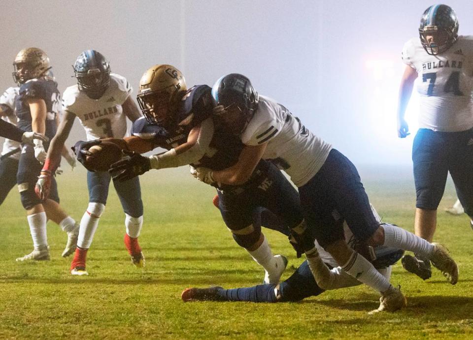 Central Catholic’s Aiden Taylor reaches across the goal line for a touchdown in the first half of the CIF Division II Northern California Regional Championship game with Bullard (Fresno) at Central Catholic High School in Modesto, Calif., Dec. 3, 2021. Central Catholic won the game 44-41.