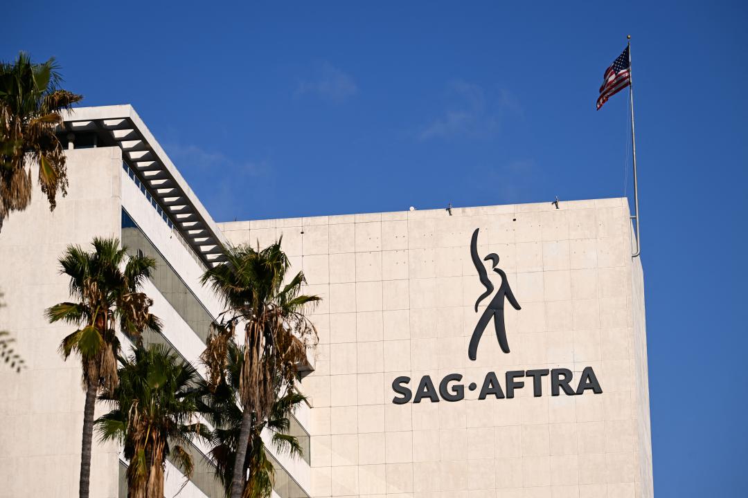 The SAG-AFTRA logo is displayed outside of the National Headquarters on Wilshire Blvd during the actors strike in Los Angeles, California on October 24, 2023. SAG-AFTRA members walked off film and TV sets in July, over terms including pay and the use of artificial intelligence. The strike has surpassed 100 days, and a series of high-level talks abruptly collapsed in acrimonious fashion. (Photo by Patrick T. Fallon / AFP) (Photo by PATRICK T. FALLON/AFP via Getty Images)