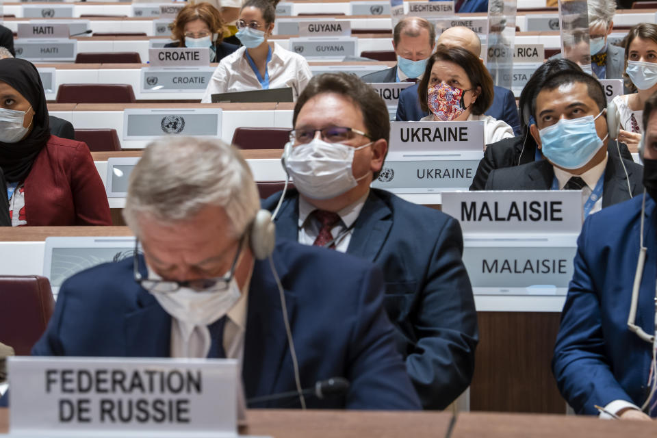 Russian ambassador Gennady Gatilov, left, and Ukraine's ambassador Yevheniia Filipenko, right, listen to a speech, during the 49th session of the UN Human Rights Council about the Urgent Debate on the "situation of human rights in Ukraine stemming from the Russian aggression" at the European headquarters of the United Nations in Geneva, Switzerland, Thursday, March 3, 2022. (Martial Trezzini/Keystone via AP)