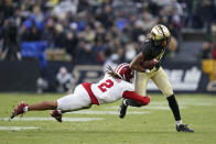 Purdue's Milton Wright (0) is tackled by Indiana defensive back Reese Taylor (2) during the first half of an NCAA college football game, Saturday, Nov. 27, 2021, in West Lafayette, Ind.(AP Photo/Darron Cummings)