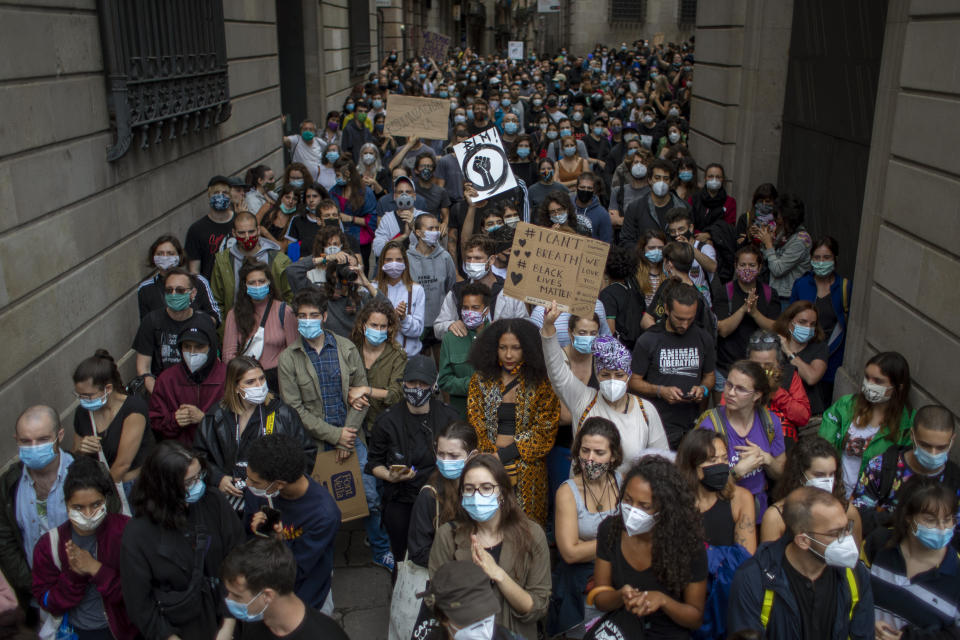 People gather in Barcelona, Spain, Sunday, June 7, 2020, during a demonstration over the death of George Floyd, a black man who died after being restrained by Minneapolis police officers on May 25. (AP Photo/Emilio Morenatti)