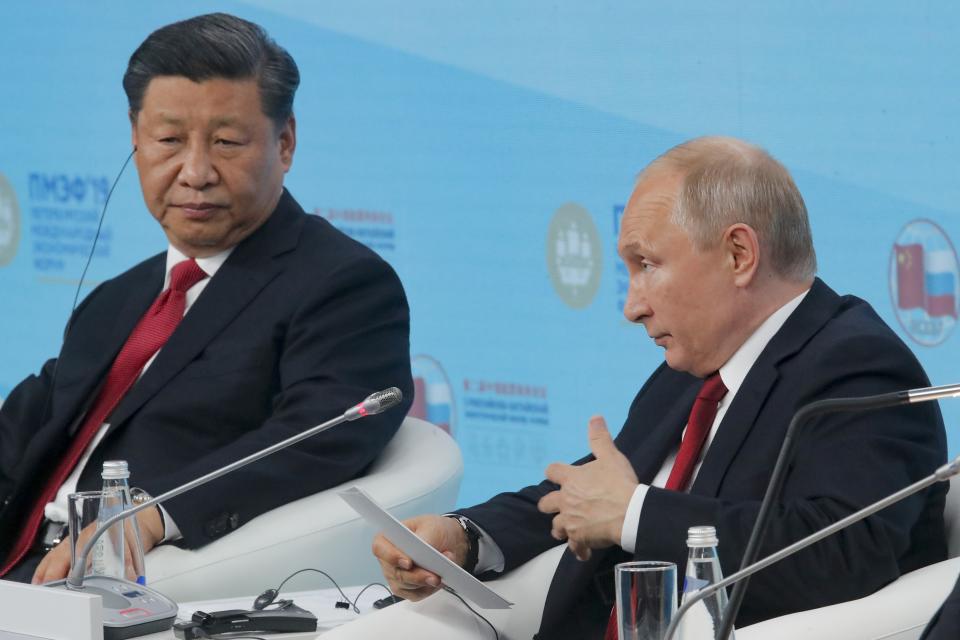 Russian President Vladimir, right, and Chinese President Xi Jinping attend a plenary session at the St. Petersburg International Economic Forum in St. Petersburg, Russia, Friday, June 7, 2019. (AP Photo/Dmitri Lovetsky)