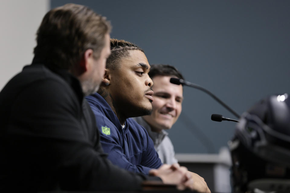 Seattle Seahawks 2024 first round draft pick, Byron Murphy II, center, speaks as he is introduced by general manager John Schneider, left, and head coach Mike Macdonald, right, during a news conference at the NFL team's headquarters, Thursday, May 2, 2024, in Renton, Wash. (AP Photo/John Froschauer)