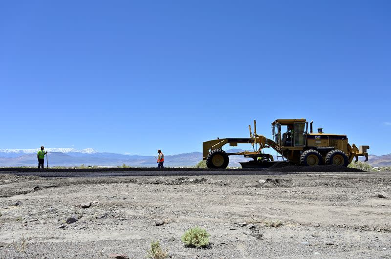 FILE PHOTO: Nevada Department of Transportation workers repair the roadway along U.S. Highway 95 after a strong earthquake struck near Tonopah