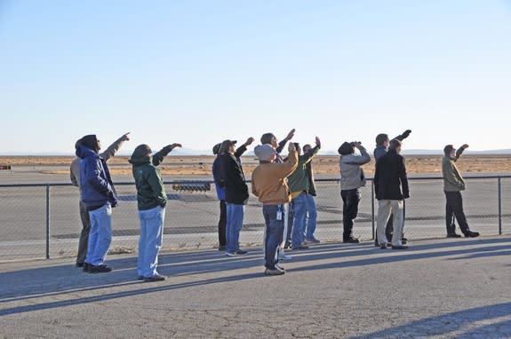 Skywatchers view Virgin Galactic's SpaceShipTwo's glide to tarmac touchdown at the Mojave Air and Space Port in California.