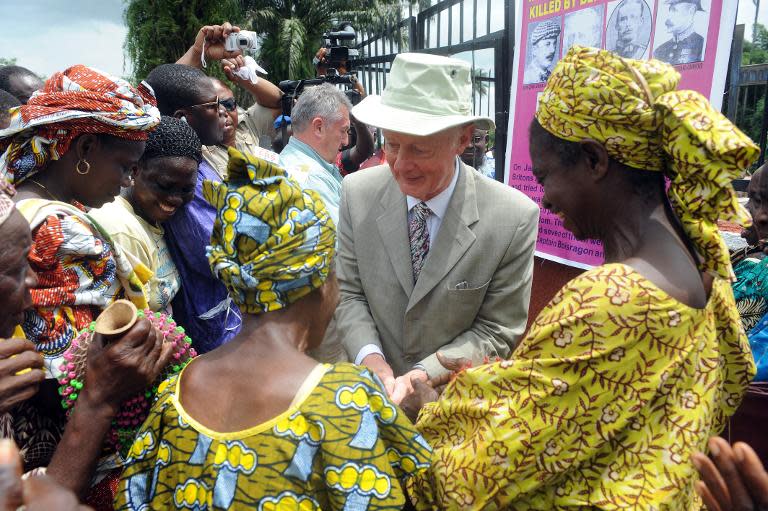 Retired hospital consultant Mark Walker greets women who danced to welcome him to Ugbineh, near Benin City, Nigeria, where British soldiers were killed during the invasion of the city in 1897, on June 21, 2014