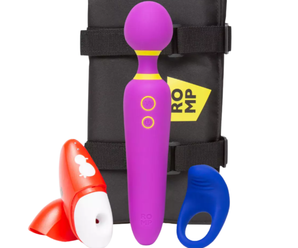 Lovehoney's three-piece ROMP kit featuring a red clitorial stimilator, a purple and yellow wand and a vibrant blue cock ring infront of a black velcro tie up back inrfont of a white background.