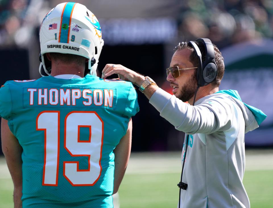 Dolphins coach Mike McDaniel talks to quarterback Skylar Thompson on the sideline during Sunday's game against the Jets.