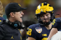 Michigan head coach Jim Harbaugh watches play during the second half of the Orange Bowl NCAA College Football Playoff semifinal game against Georgia, Friday, Dec. 31, 2021, in Miami Gardens, Fla. (AP Photo/Rebecca Blackwell)