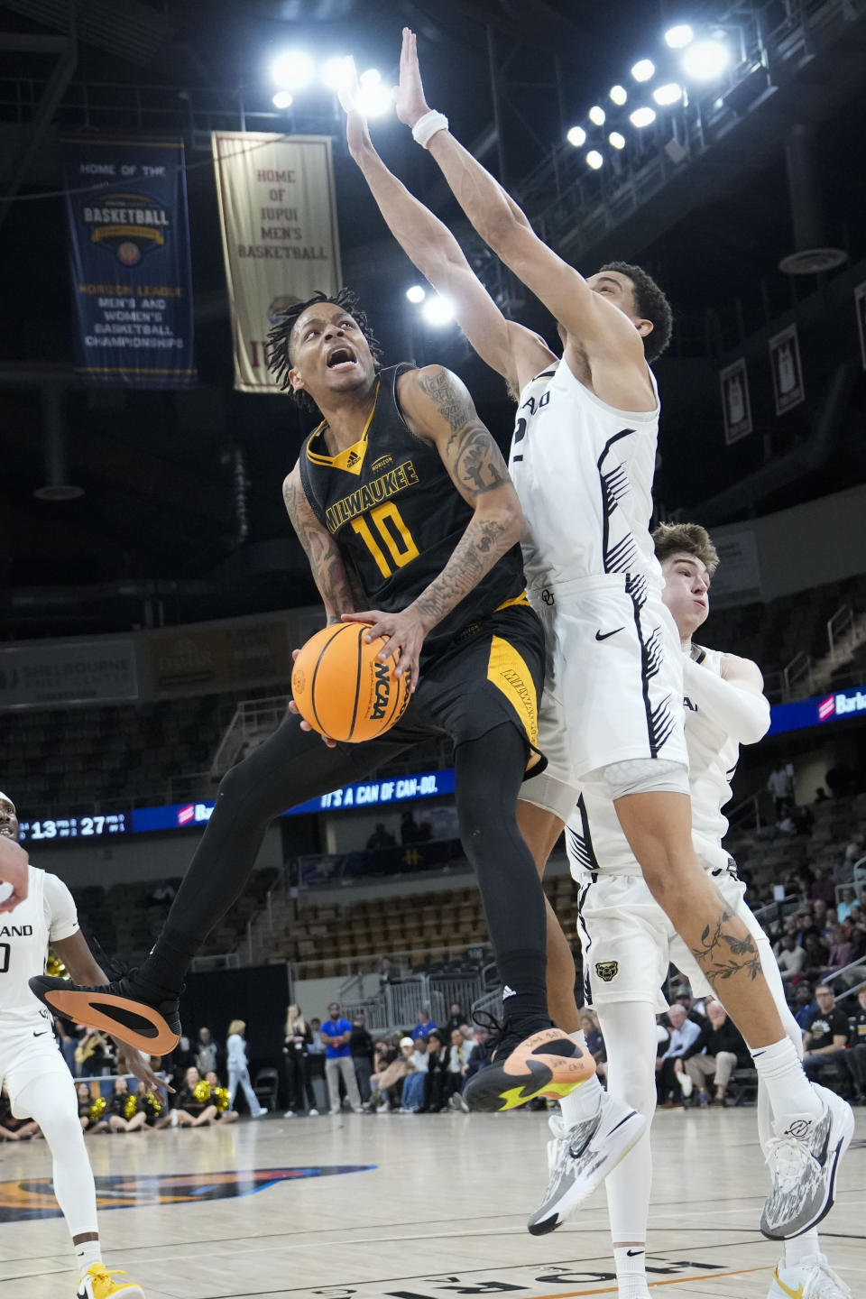 Milwaukee guard BJ Freeman (10) shoots against Oakland forward Chris Conway (2) during the second half of an NCAA college basketball game for the championship of the Horizon League men's tournament in Indianapolis, Tuesday, March 12, 2024. (AP Photo/AJ Mast)