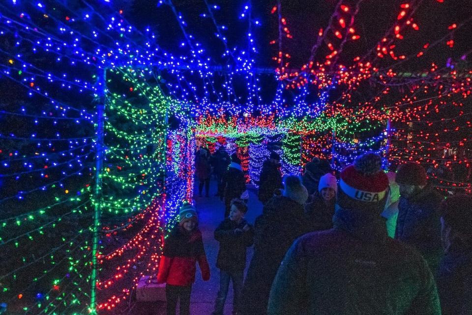 Visitors to the annual "Capture the Spirit" holiday festival in Sister Bay stroll through the tunnel of lights, one of the more popular light displays each holiday season in the village's Waterfront Park.