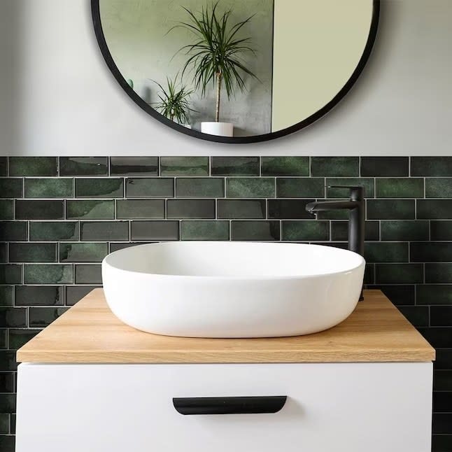 Green backsplash behind a bathroom vanity