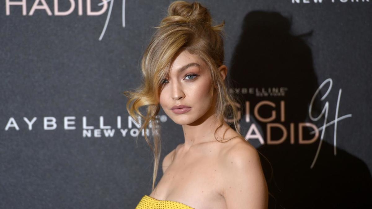 Gigi Hadid stuns in yellow mini-dress and matching cape as she attends her  Maybelline launch party in London