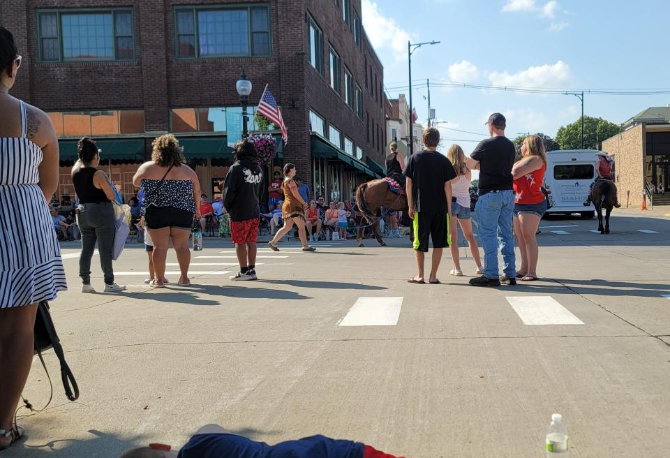 A woman dressed as a Native American with her hands tied at a Fourth of July parade in Muscatine, Iowa, sparked outrage.