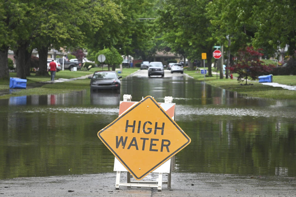 FILE - In this June 26, 2021, file photo, a sign warns of high water on a flooded Interstate 75 at 7 Mile Road in Detroit. The Federal Emergency Management Agency has approved about $29 million in grants for Detroit residents whose homes and property suffered damage from heavy flooding during a late June storm. (Max Ortiz/Detroit News via AP, File)