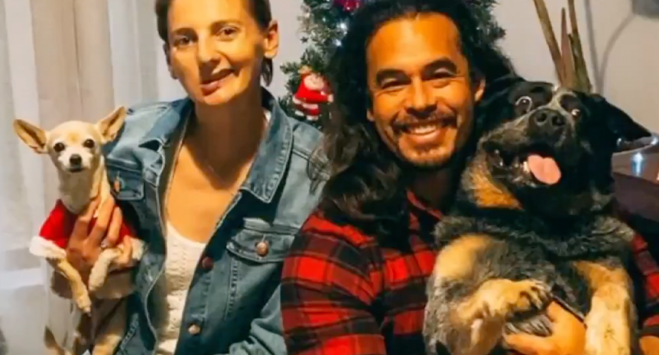 Bridgette O’Shannessy posing for a photo with her partner and their pet dogs. 