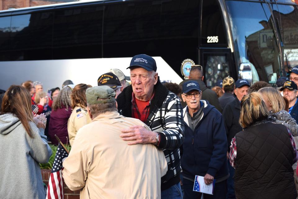 U.S. Army veteran Leonard Bilek greets friends and family along with the other 22 veterans who took the honor trip to Washington, D.C., during a welcome home ceremony held Sunday in Shreve.