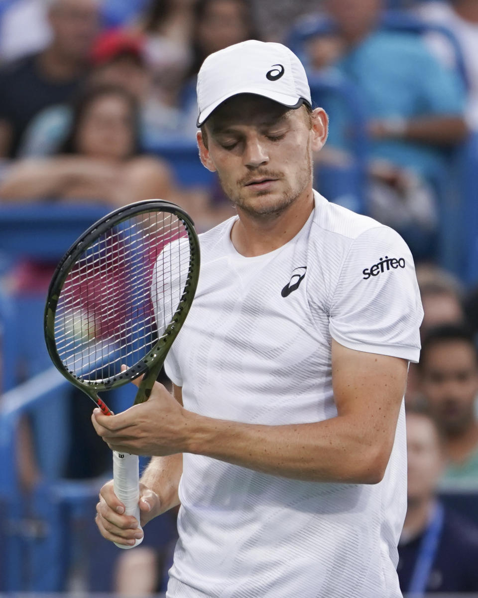 David Goffin, of Belgium, reacts during a semifinal against Roger Federer, of Switzerland, at the Western & Southern Open tennis tournament, Saturday, Aug. 18, 2018, in Mason, Ohio. Goffin retired from the match. (AP Photo/John Minchillo)