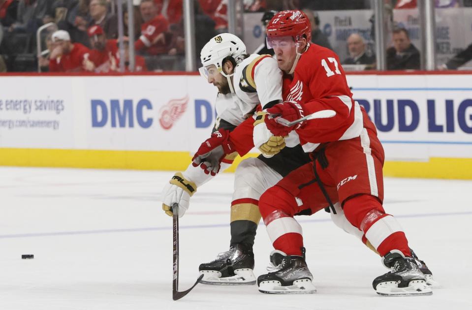 Vegas Golden Knights defenseman Nicolas Hague, left, becomes entangled with Detroit Red Wings right wing Daniel Sprong (17) during the second period of an NHL hockey game Saturday, Jan. 27, 2024, in Detroit. (AP Photo/Duane Burleson)